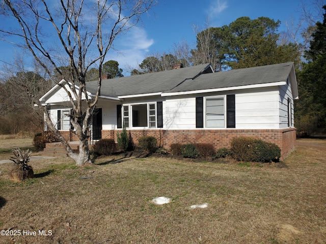 single story home with a front yard, a chimney, and brick siding