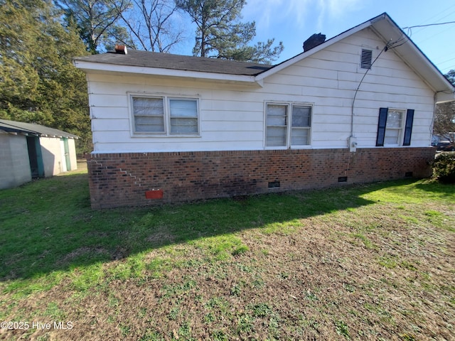 view of property exterior featuring crawl space, a lawn, and brick siding