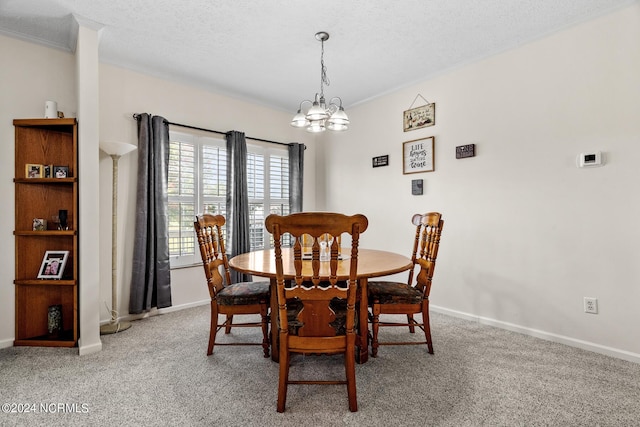 dining area with a notable chandelier, a textured ceiling, baseboards, and carpet flooring