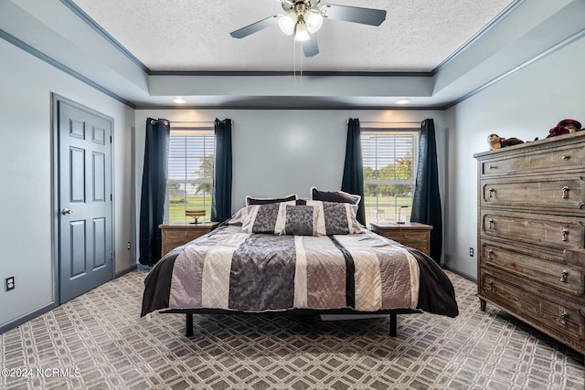 bedroom featuring a textured ceiling, ornamental molding, multiple windows, and light colored carpet