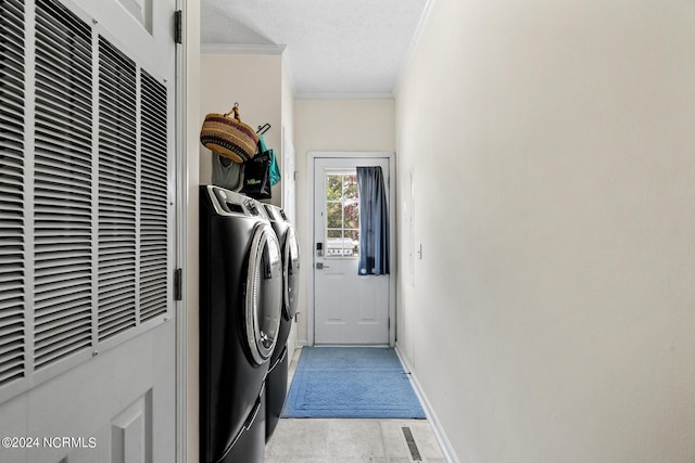 laundry area featuring a textured ceiling, laundry area, separate washer and dryer, ornamental molding, and a heating unit