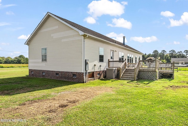 back of property featuring crawl space, central air condition unit, a deck, and a yard