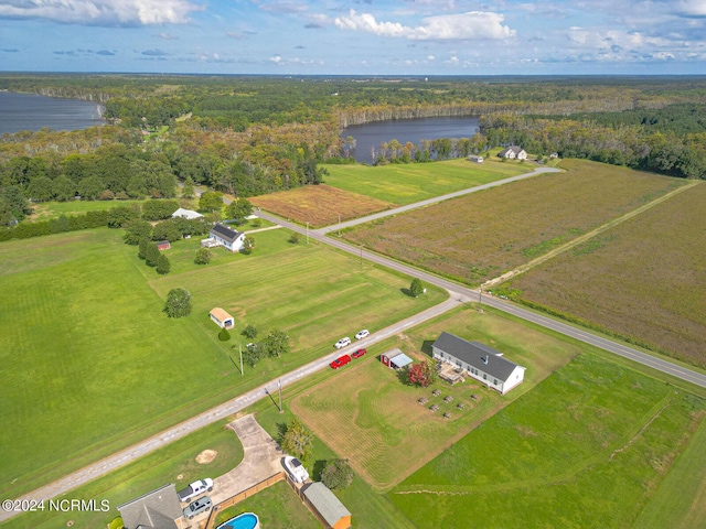 drone / aerial view with a water view, a view of trees, and a rural view