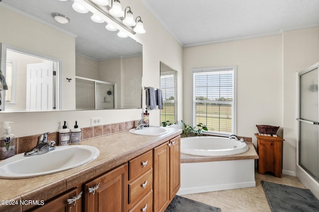 full bathroom featuring a stall shower, ornamental molding, a garden tub, and a sink