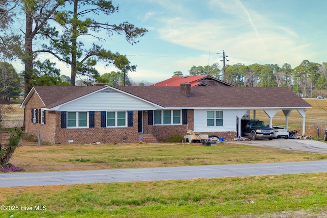 ranch-style house with brick siding, crawl space, an attached carport, and a front yard