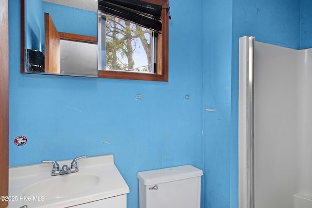 bathroom with toilet and vanity