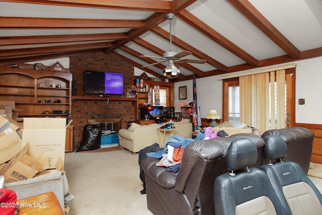 living area featuring a brick fireplace, vaulted ceiling with beams, concrete floors, and a ceiling fan