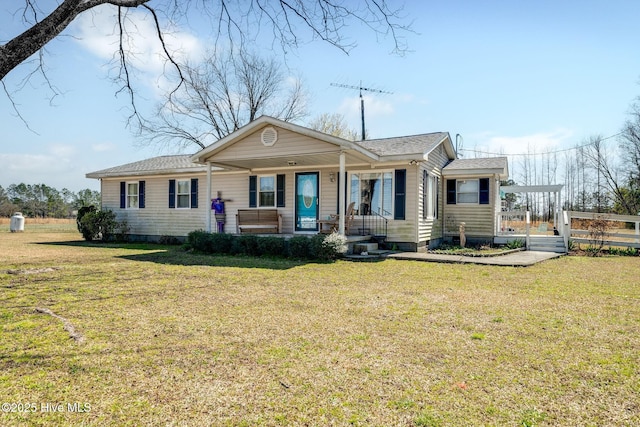 view of front of home featuring covered porch and a front lawn