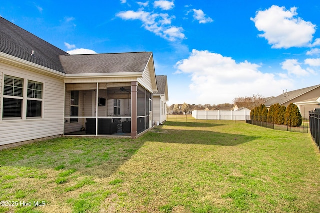 view of yard featuring a sunroom, a fenced backyard, and ceiling fan