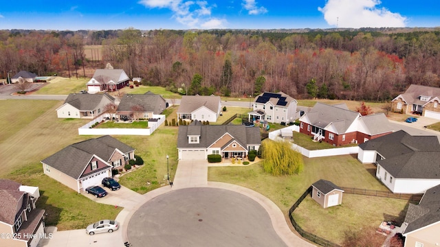 aerial view with a wooded view and a residential view