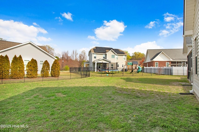 view of yard featuring a playground and fence