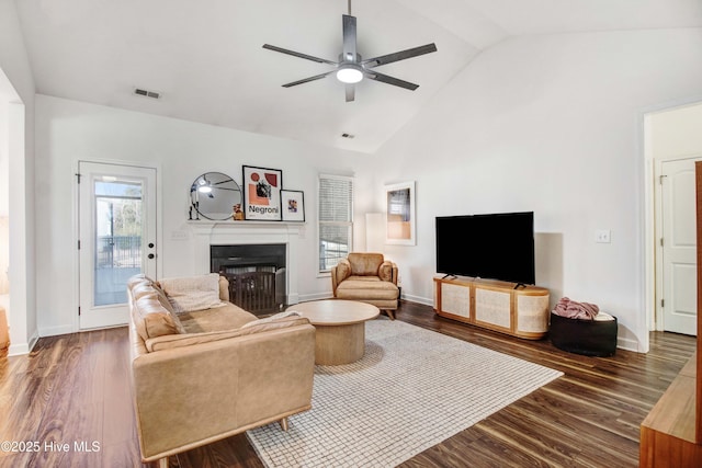 living area featuring ceiling fan, dark wood-style flooring, a fireplace, visible vents, and baseboards