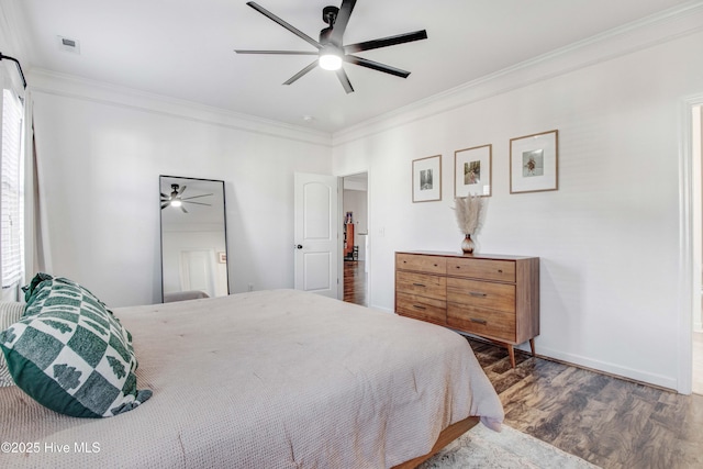 bedroom with wood finished floors, a ceiling fan, baseboards, visible vents, and crown molding