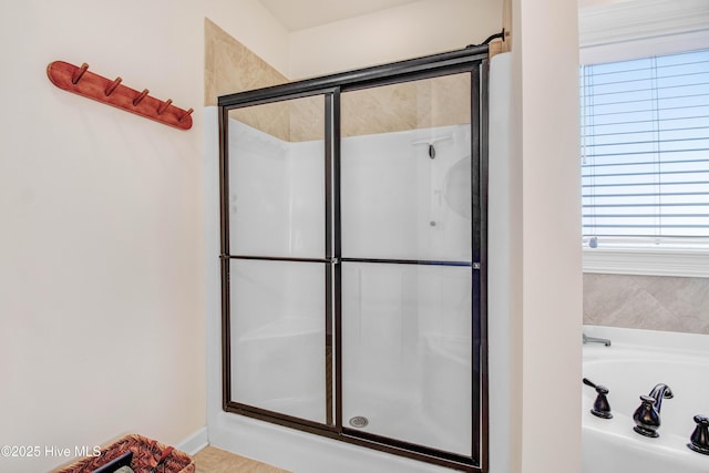 bathroom featuring a stall shower and a garden tub