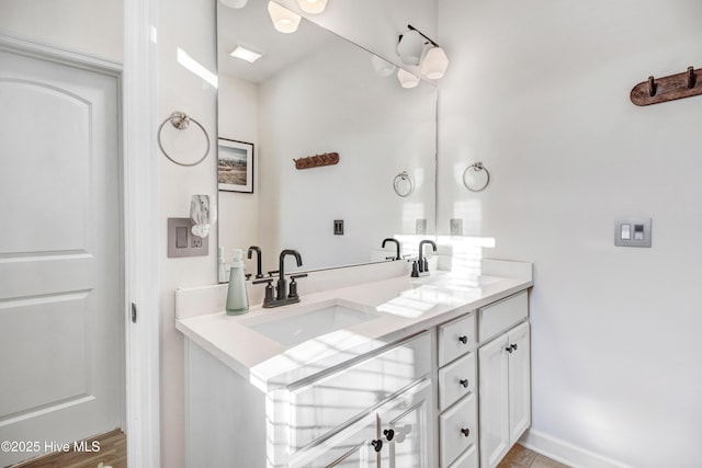 bathroom featuring double vanity and a sink