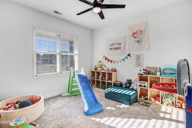 rec room featuring carpet floors, baseboards, visible vents, and a ceiling fan