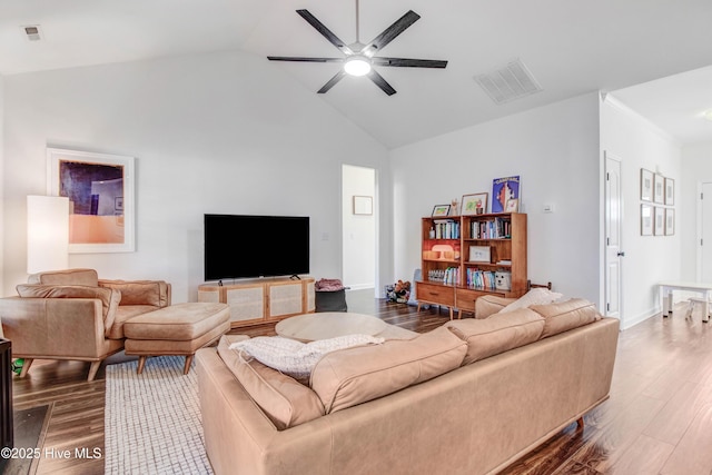 living area featuring high vaulted ceiling, dark wood-style floors, visible vents, and a ceiling fan