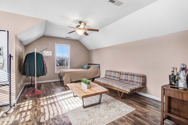 bedroom featuring lofted ceiling, wood finished floors, visible vents, and baseboards