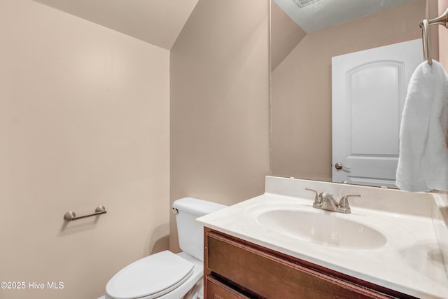 bathroom featuring toilet and vanity