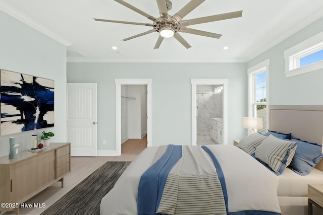 bedroom with ornamental molding, a spacious closet, baseboards, and wood finished floors