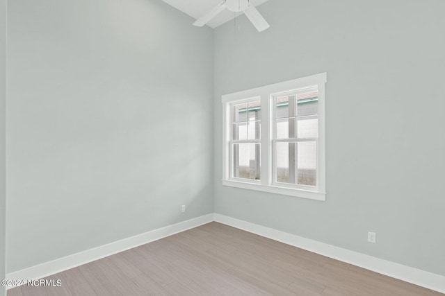 unfurnished room featuring ceiling fan, baseboards, and wood finished floors