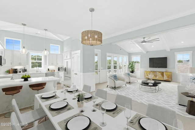 dining space with a wainscoted wall, vaulted ceiling with beams, recessed lighting, ornamental molding, and ceiling fan