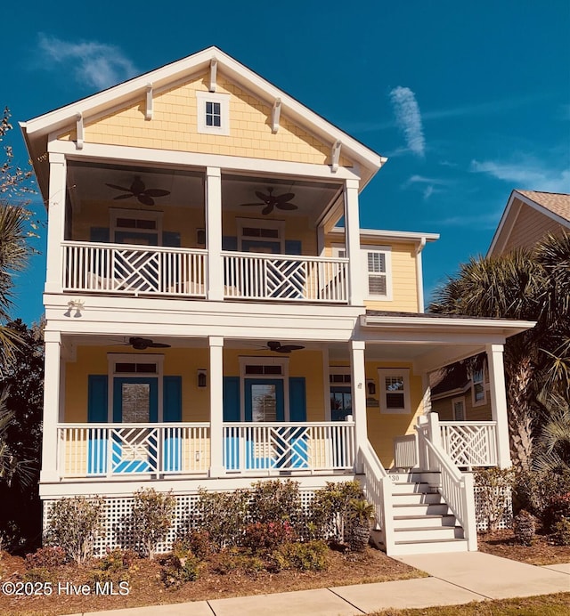 view of front of home with a balcony, covered porch, and a ceiling fan