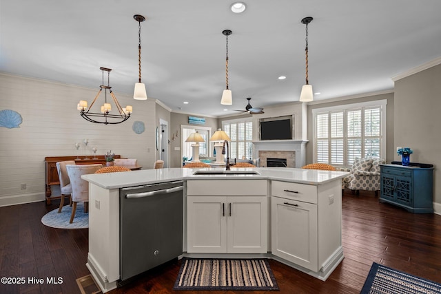 6430 Craller Way, Ocean Isle Beach, NC 28469 - kitchen featuring stainless steel dishwasher, a sink, a fireplace, ceiling fan, and crown molding