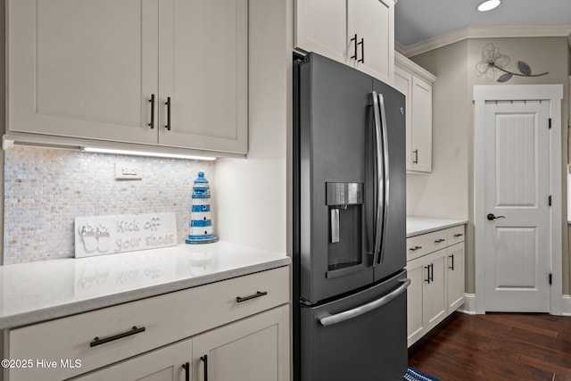 6430 Craller Way, Ocean Isle Beach, NC 28469 - kitchen featuring stainless steel fridge, light countertops, decorative backsplash, white cabinets, and ornamental molding