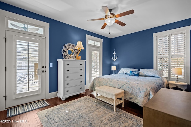 bedroom featuring access to outside, ceiling fan, baseboards, and wood finished floors