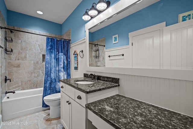 bathroom with vanity, shower / bath combo with shower curtain, and toilet