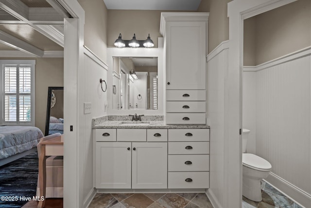 6430 Craller Way, Ocean Isle Beach, NC 28469 - bathroom featuring connected bathroom, toilet, vanity, and a decorative wall
