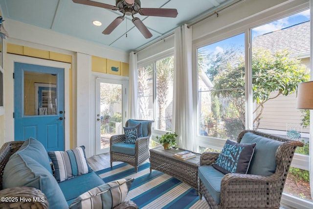 sunroom / solarium with a ceiling fan