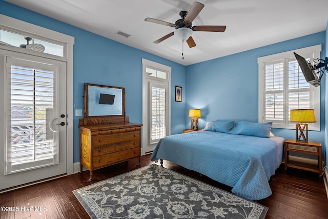 bedroom featuring dark wood-style flooring, visible vents, and a ceiling fan