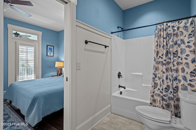 bathroom with toilet, shower / bath combination with curtain, tile patterned flooring, and a ceiling fan