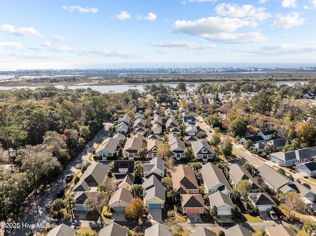 drone / aerial view with a residential view and a water view