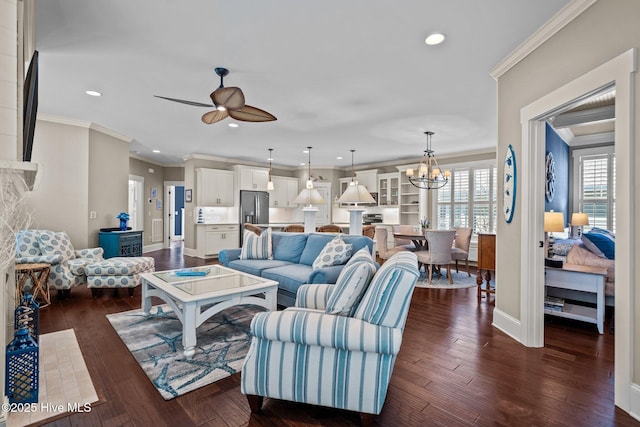 living area with baseboards, ornamental molding, and dark wood finished floors