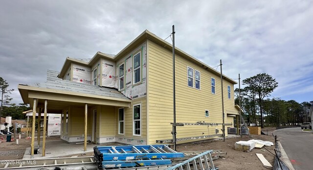 view of front of property featuring a residential view and a standing seam roof