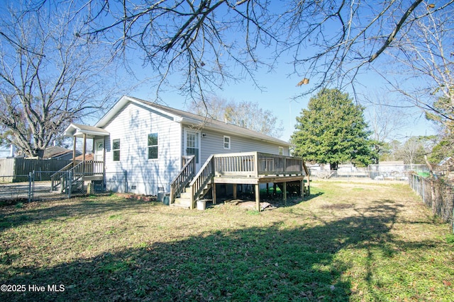 rear view of house featuring a fenced backyard, a lawn, and a wooden deck