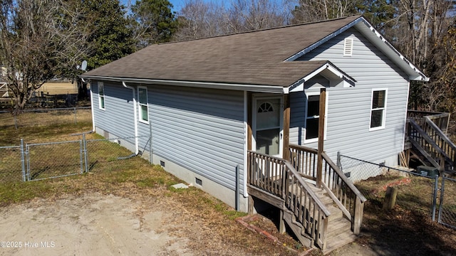 view of front of property featuring crawl space, a shingled roof, a gate, and fence