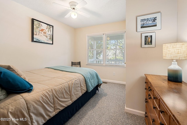 carpeted bedroom with a ceiling fan, a textured ceiling, and baseboards