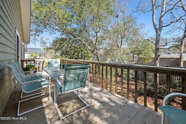 wooden terrace featuring outdoor dining space