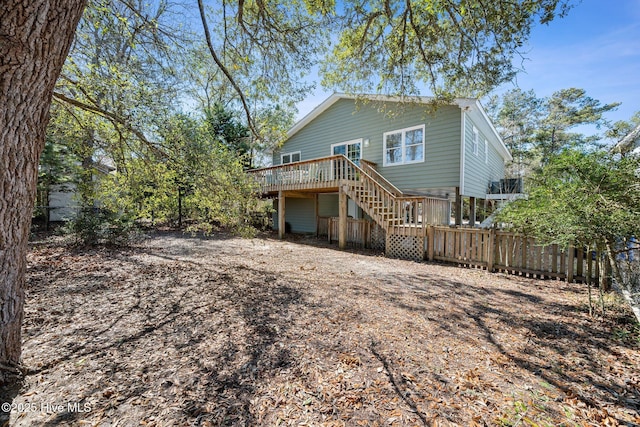 back of house with a deck, stairway, and fence