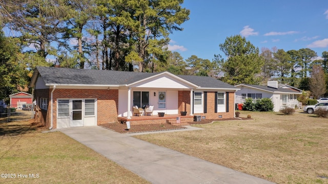 single story home featuring covered porch, brick siding, a front lawn, and an attached garage