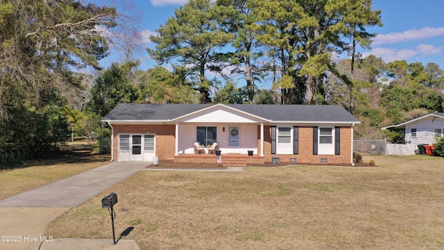 ranch-style home with covered porch, brick siding, fence, crawl space, and a front lawn