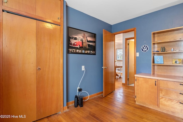 hallway with baseboards and wood finished floors