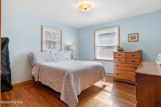 bedroom featuring light wood-style flooring and baseboards