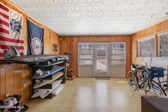 interior space featuring speckled floor and wooden walls