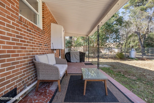 view of patio featuring fence and an outdoor living space