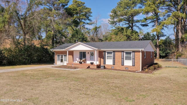 ranch-style home with crawl space, brick siding, fence, and a front lawn